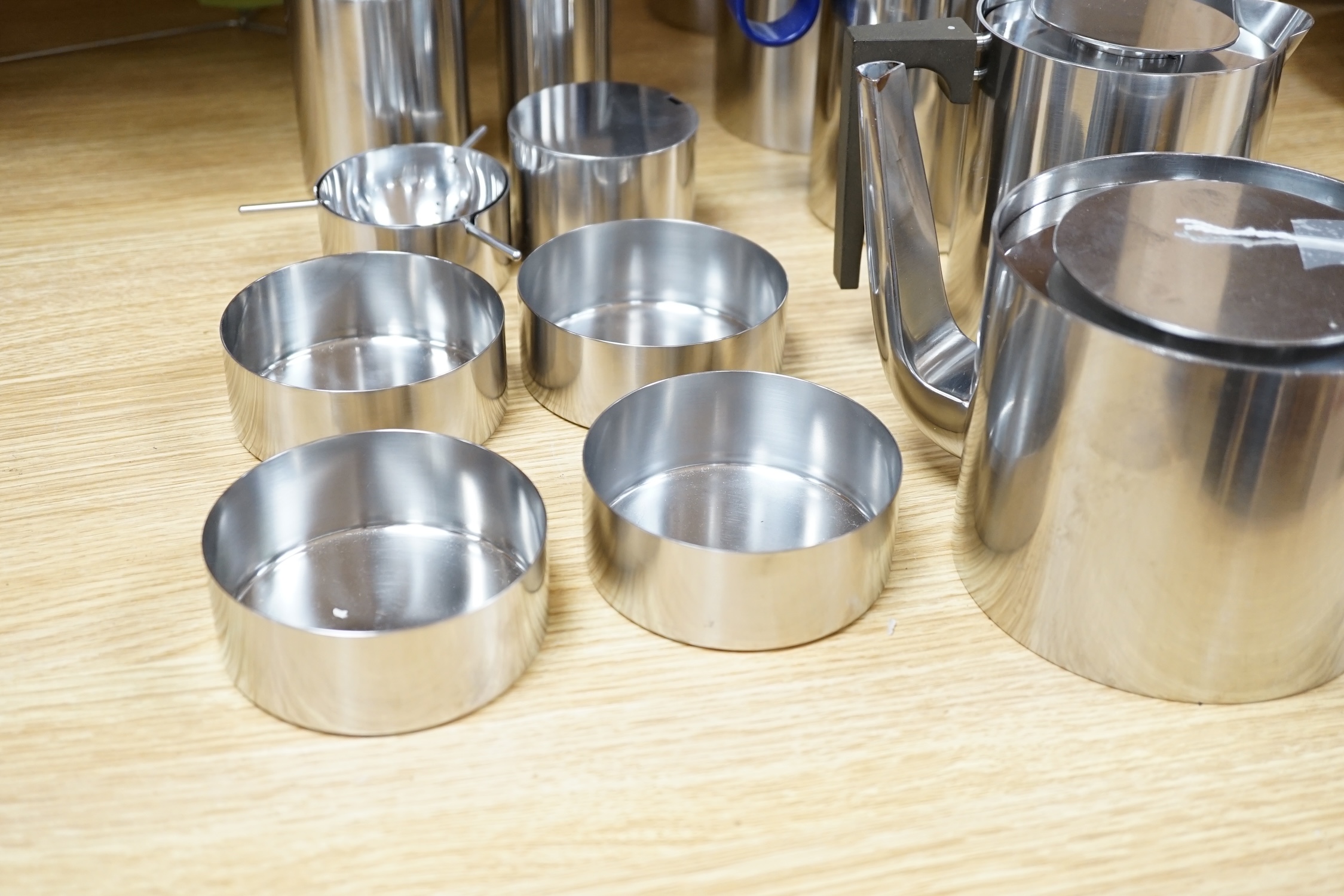 A thirteen piece suite of Arne Jacobsen stainless steel cylinder ware, coffee pot 24cm high
